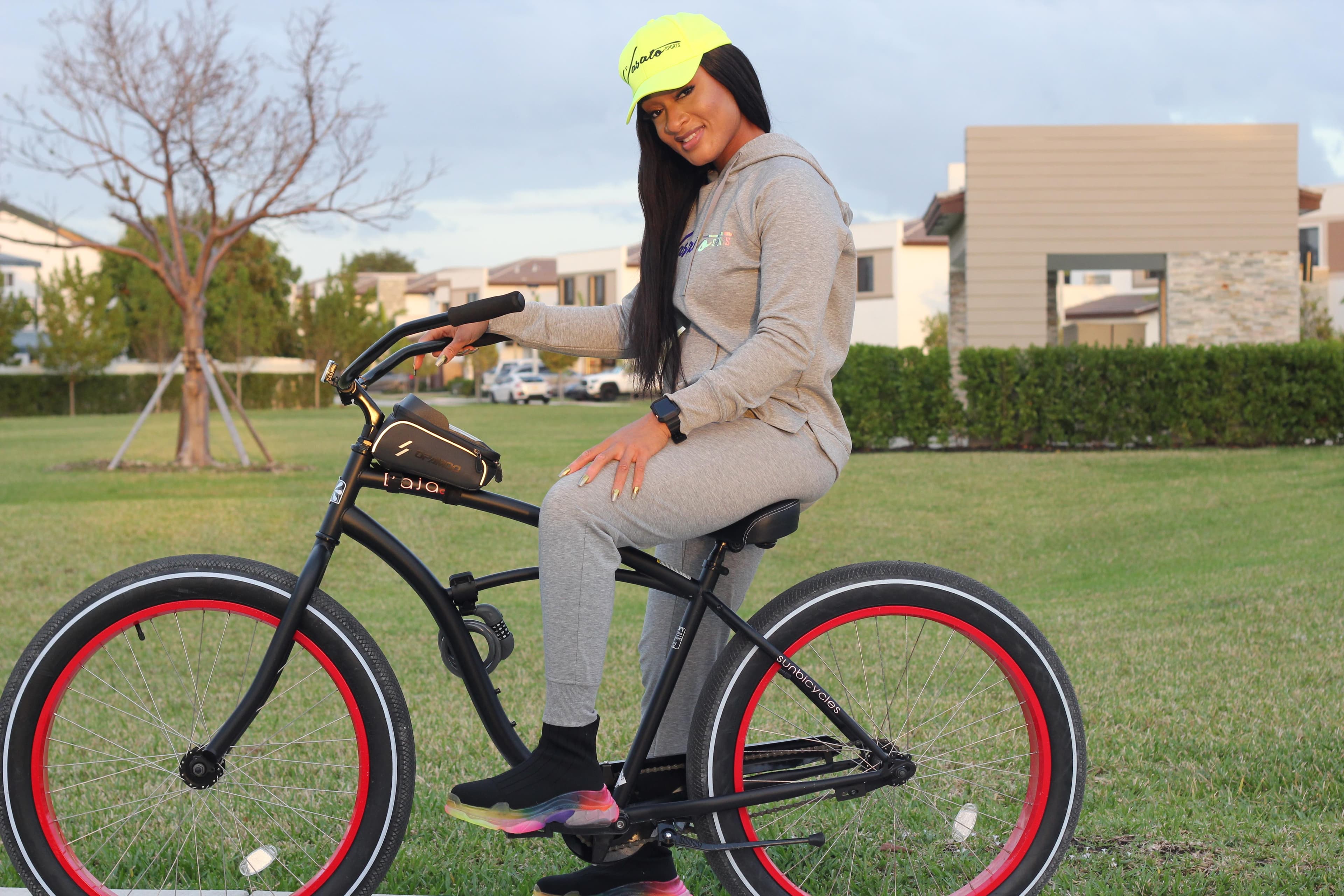 Olatunde wearing a Vasato tracksuit beside a bicycle