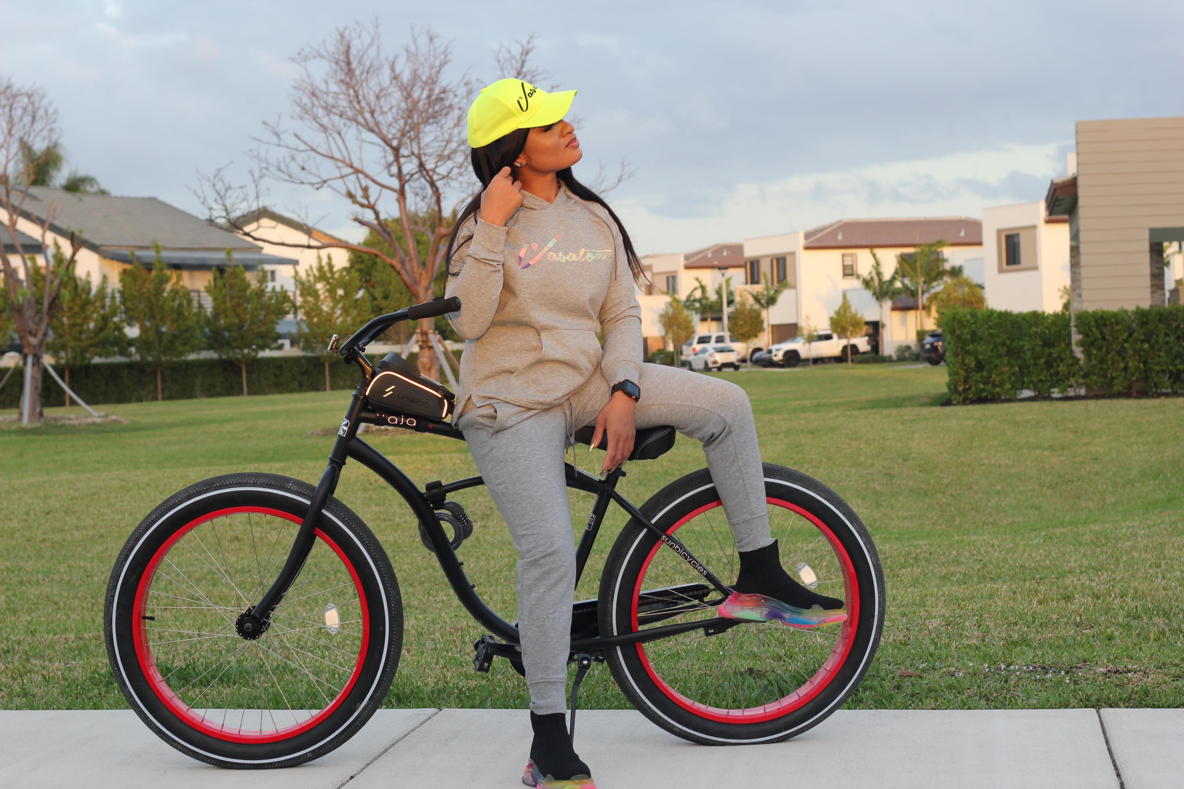 Olatunde in Vasato activewear seated on a bicycle